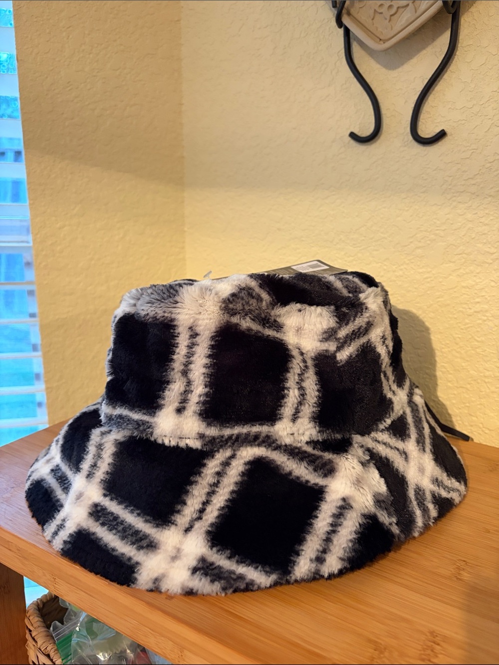 Sprigs reversible Faux Fur bucket hat in black and black and white pattern